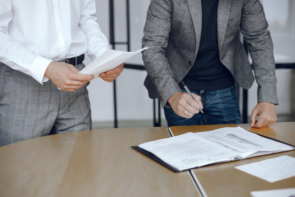 business-men-sitting-lawyers-s-desk-people-signing-important-documents